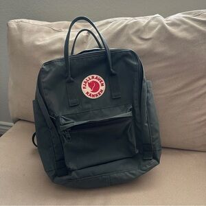 Fjällräven Kånken backpack in a dark green color.